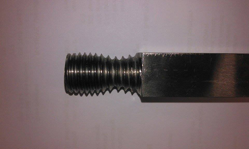 Figure 17 Examples of failure in machined threaded ends in SENT specimens in M01, with (a) yielding in a specimen with a notch depth of a/W of 0.33