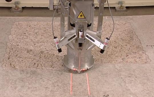 Figure 9 The laser scabbling system in operation. Still image taken from a video sequence.