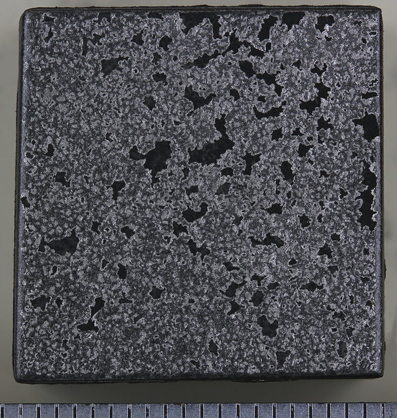 Figure 1: UNS N06601 (tested in the as-received surface condition) after 336h at 1100°C in flowing 90%CO-2.5%H2-Ar while under TiO2 powder. A millimetre scale is included.