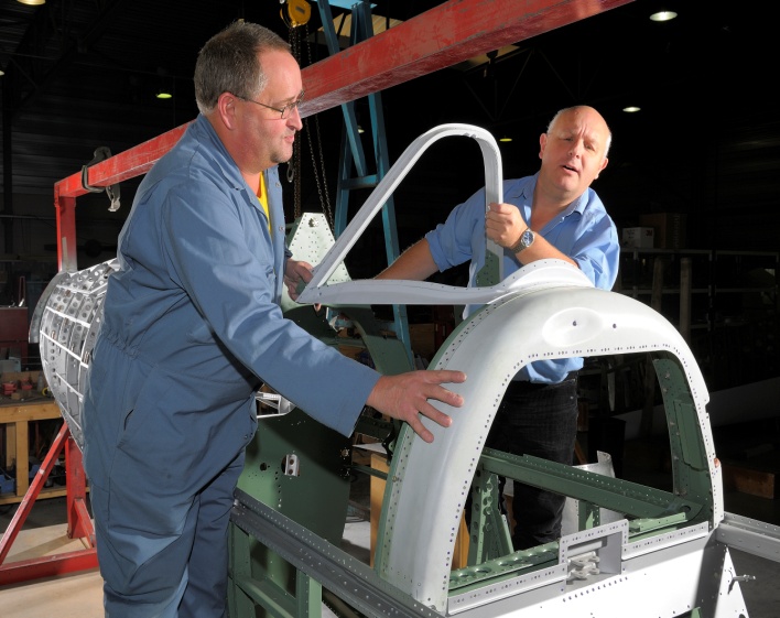The magnesium Spitfire canopy hoop being positioned for installation at ARC