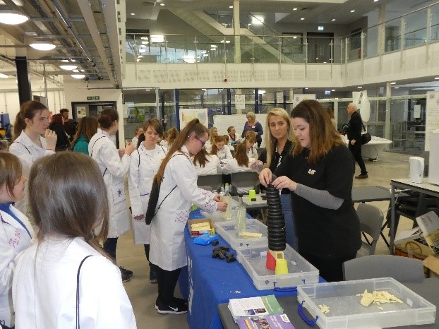 Molly and Sarah Caterpillar apprentices demonstrating 'Welding with Chocolate'