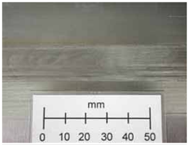 Figure 4a The surface of a Ti-6Al-4V weld (left) and macrostructure of a weld (right) made with SSFSW tool